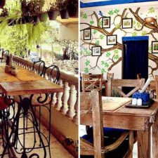 A richly decorated and aesthetic corner of Taruveda Bistro Jaipur, showcasing unique furniture, colorful wall art, and warm, inviting lighting.